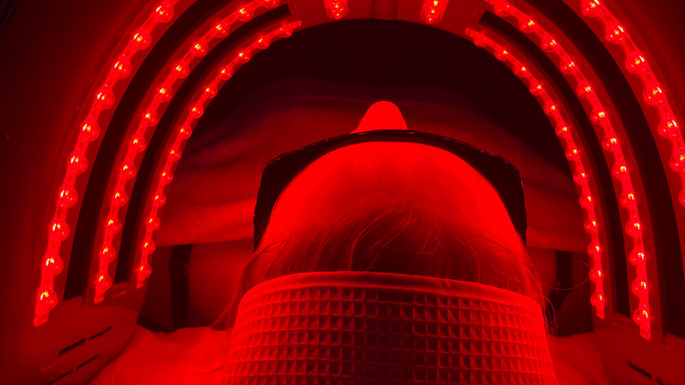 Woman under LED red light therapy