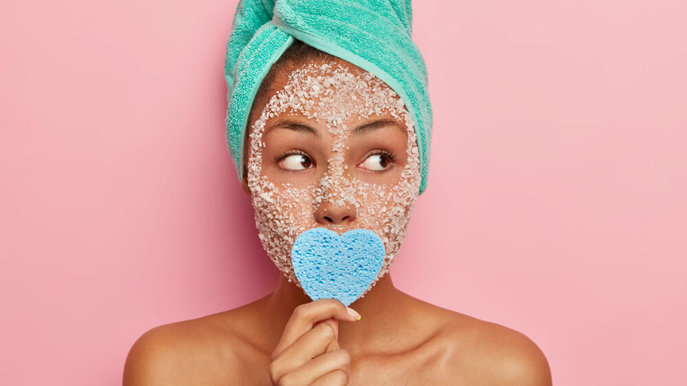 Beautiful woman has scrub facial mask