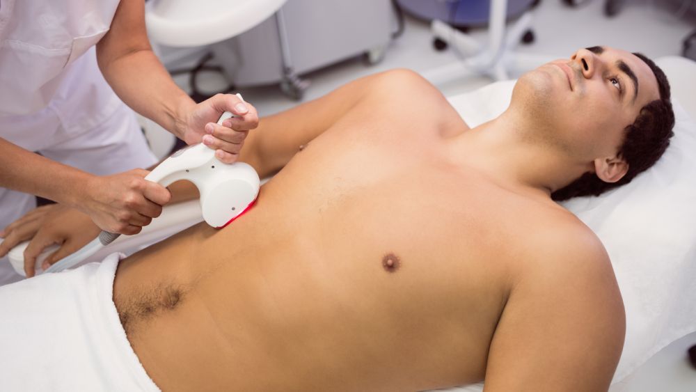 Man receiving laser hair removal treatment