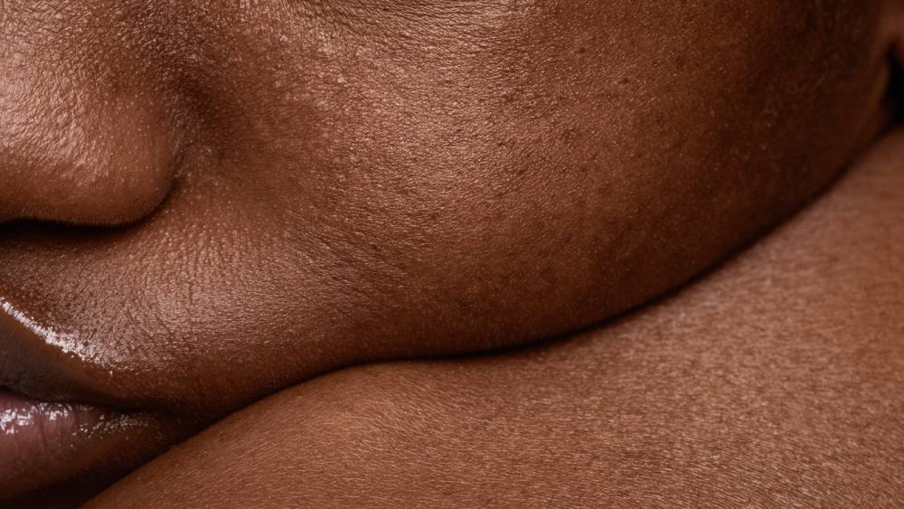 Close-up woman's face with dark skin texture