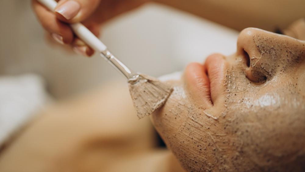 Woman doing skin exfoliation at skincare clinic