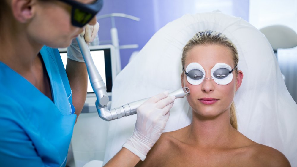 Female patient getting RF lifting procedure by a dermatologist