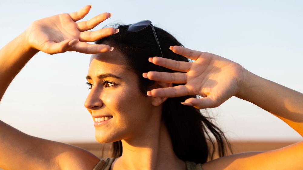 Smiley woman outdoors under sunlight covering her face